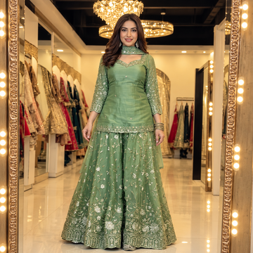 Front view of sage green embroidered kurta, pants and dupatta set